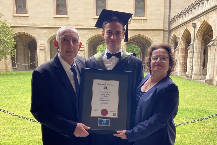 Dr Sulejman in academic dress at his graduation with his parents
